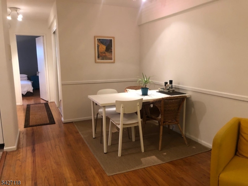 130 Orient Way, Unit 2K Rutherford, NJ 07070 - Photo 7 of 16 a view of a dining room with furniture and wooden floor