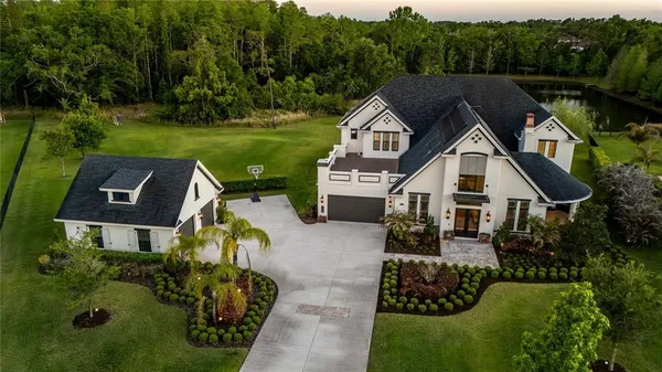 a aerial view of a house next to a yard