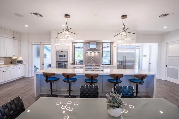 a kitchen with a sink appliances and cabinets