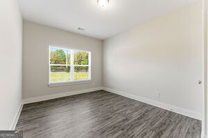 11149 Cornerstone Lane Hampton, GA 30228 - Photo 16 of 29 an empty room with wooden floor and windows