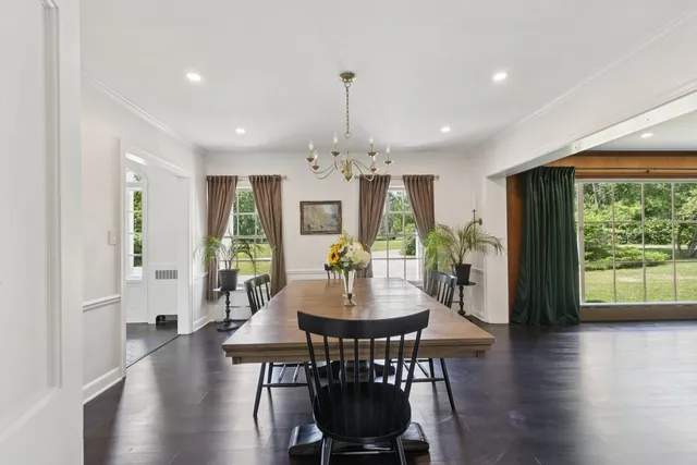 a living room with furniture a rug and wooden floor