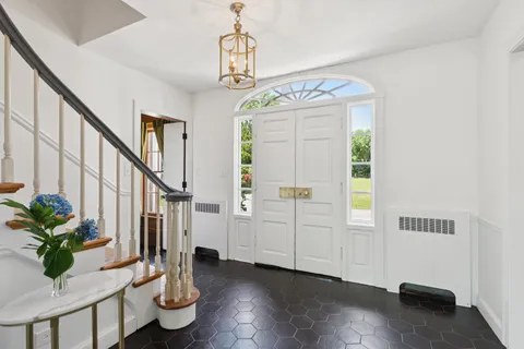 a view of a livingroom with furniture a dinning room and stairs