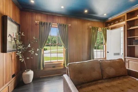 a bedroom with a large bed and wooden floor