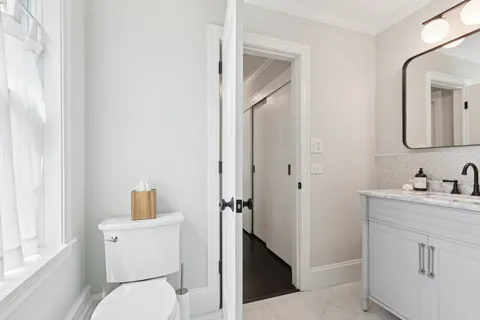 a view of a room with wooden floor and a bathroom
