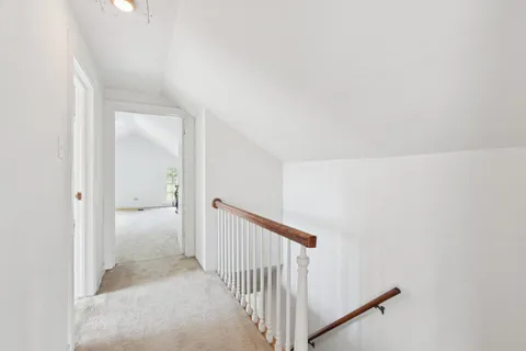 an aerial view of a house with swimming pool and large trees
