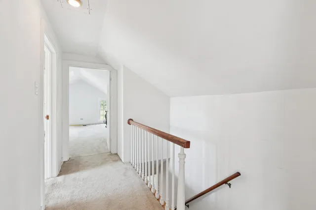 an aerial view of a house with swimming pool and large trees