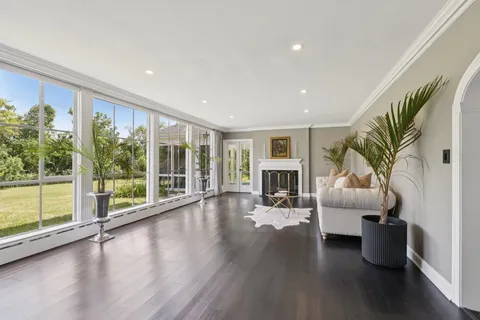 a living room with furniture and wooden floor
