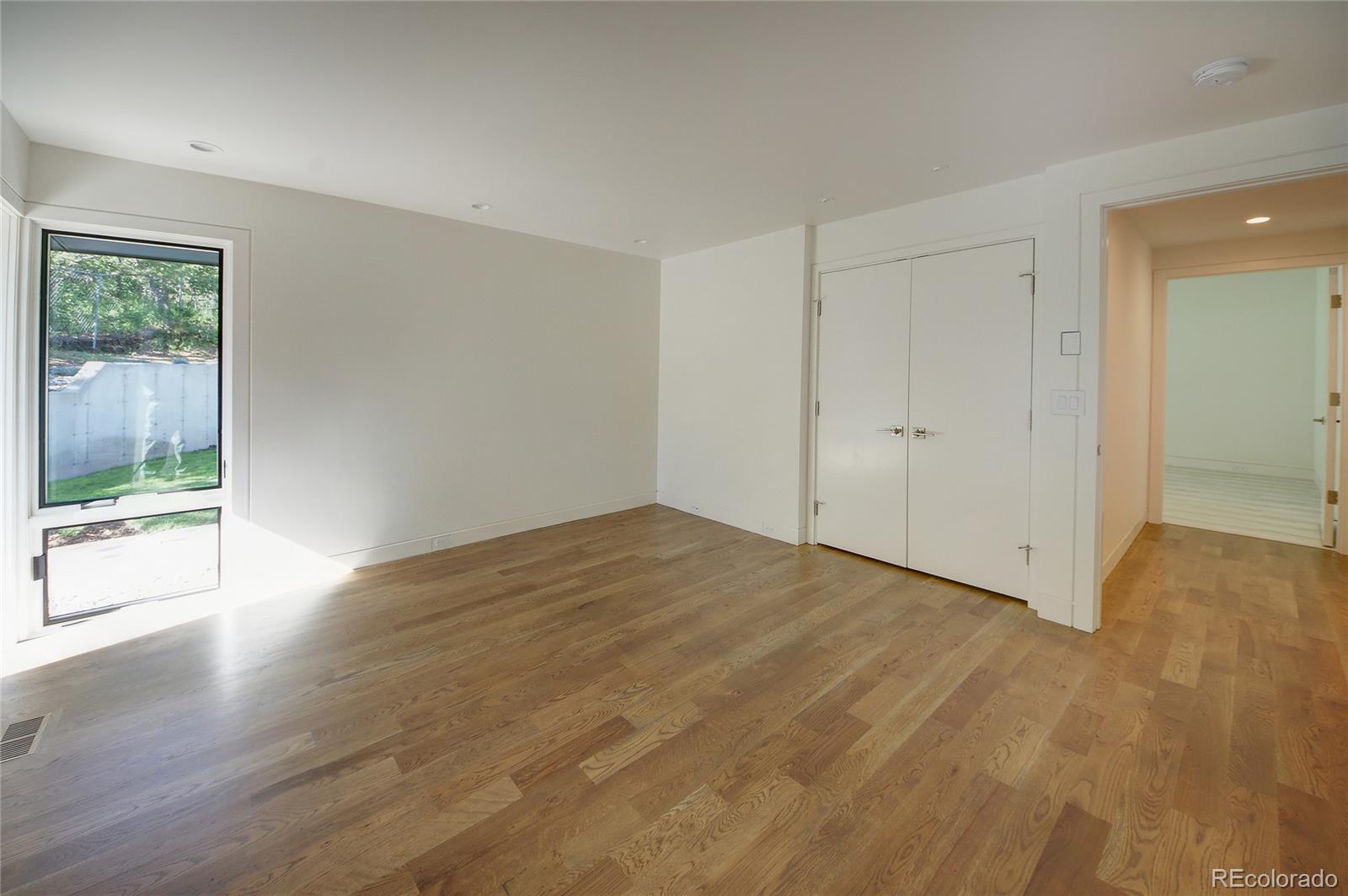 11 Thayer Road Colorado Springs, CO 80906 - Photo 21 of 37 a view of an empty room with wooden floor and a window
