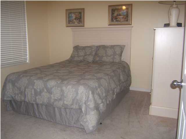 520 Santa Rosa Boulevard, Unit 110 Fort Walton Beach, FL 32548 - Photo 11 of 21 a bed sitting in a room next to a window