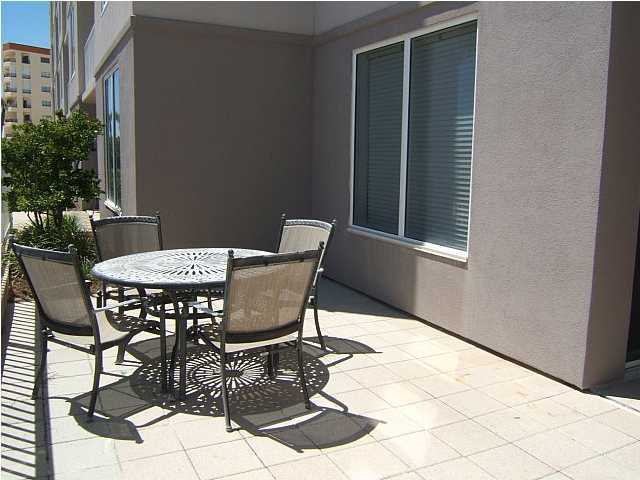 520 Santa Rosa Boulevard, Unit 110 Fort Walton Beach, FL 32548 - Photo 16 of 21 a patio with table and chairs and potted plants