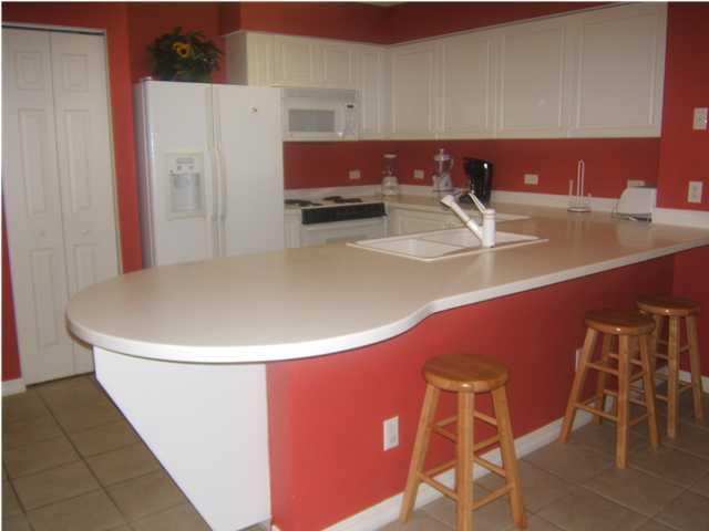 520 Santa Rosa Boulevard, Unit 110 Fort Walton Beach, FL 32548 - Photo 5 of 21 a view of a kitchen with kitchen island stainless steel appliances a sink and cabinets