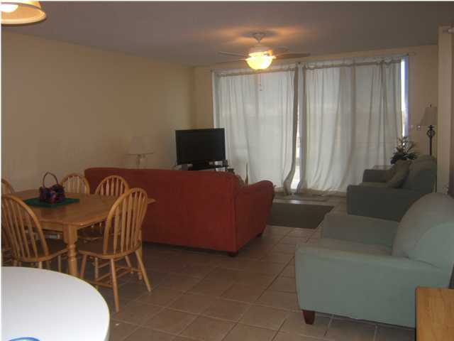 520 Santa Rosa Boulevard, Unit 110 Fort Walton Beach, FL 32548 - Photo 7 of 21 a living room with furniture a lamp and a window