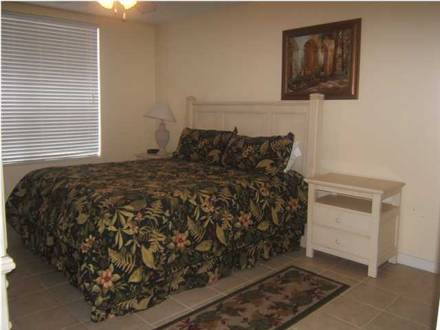 520 Santa Rosa Boulevard, Unit 110 Fort Walton Beach, FL 32548 - Photo 8 of 21 a bed sitting in a bedroom next to a window