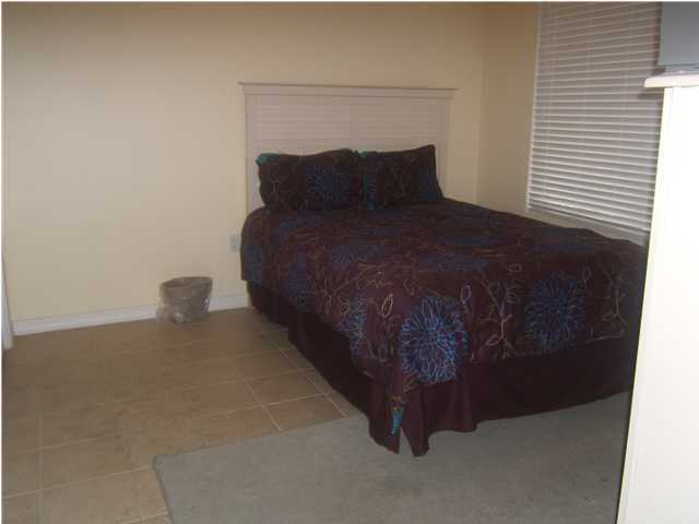 520 Santa Rosa Boulevard, Unit 110 Fort Walton Beach, FL 32548 - Photo 10 of 21 a bed sitting in a bedroom next to a window and a fireplace