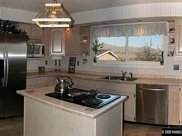 2145 Armstrong Lane Reno, NV 89509 - Photo 5 of 9 a kitchen with a stove a sink and a refrigerator