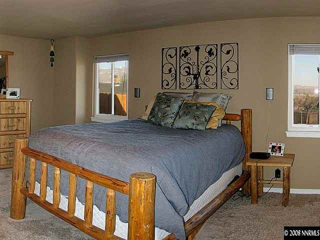 2145 Armstrong Lane Reno, NV 89509 - Photo 6 of 9 a bedroom with a bed a dresser and next to a window