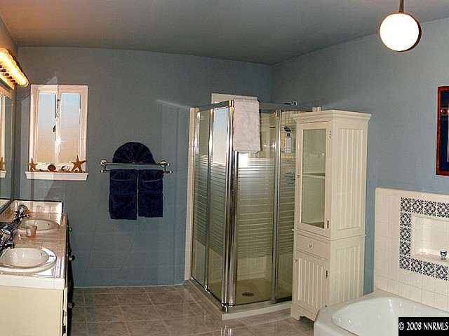 2145 Armstrong Lane Reno, NV 89509 - Photo 8 of 9 a bathroom with a sink a toilet and shower