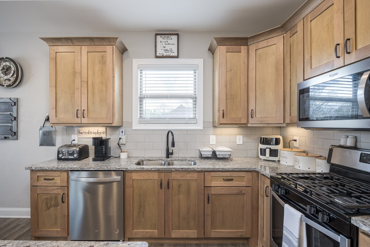2743 West County Farm Road Springfield, TN 37172 - Photo 15 of 53 a kitchen with granite countertop a sink a stove cabinets and window