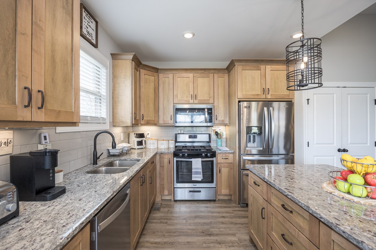 2743 West County Farm Road Springfield, TN 37172 - Photo 17 of 53 a kitchen with stainless steel appliances granite countertop a sink a stove top oven a refrigerator a counter space and cabinets