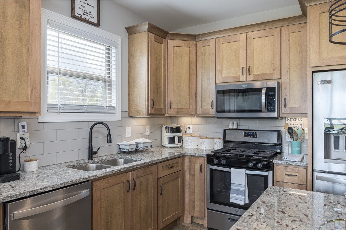 2743 West County Farm Road Springfield, TN 37172 - Photo 18 of 53 a kitchen with stainless steel appliances granite countertop a sink stove and microwave