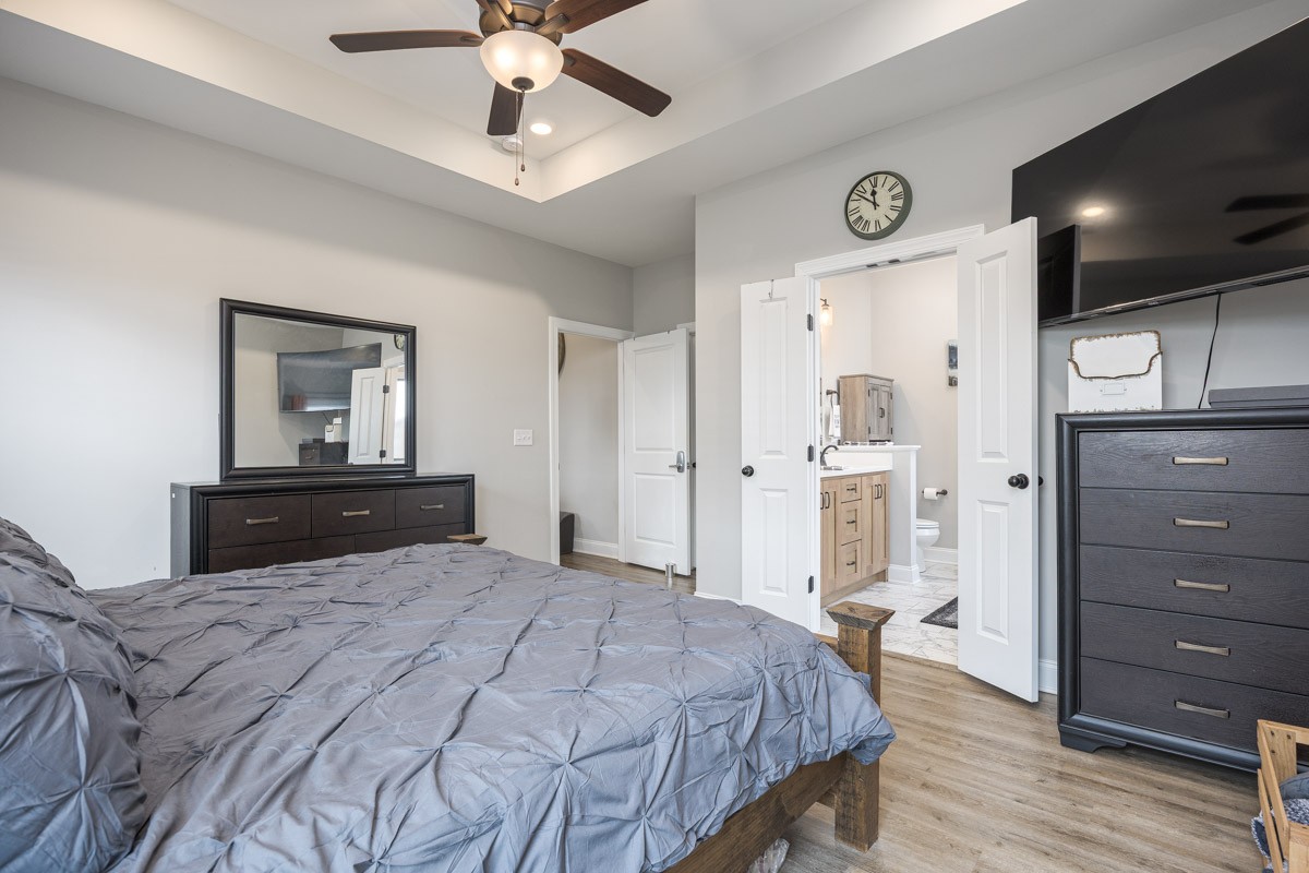 2743 West County Farm Road Springfield, TN 37172 - Photo 28 of 53 a bedroom with a bed and a chandelier