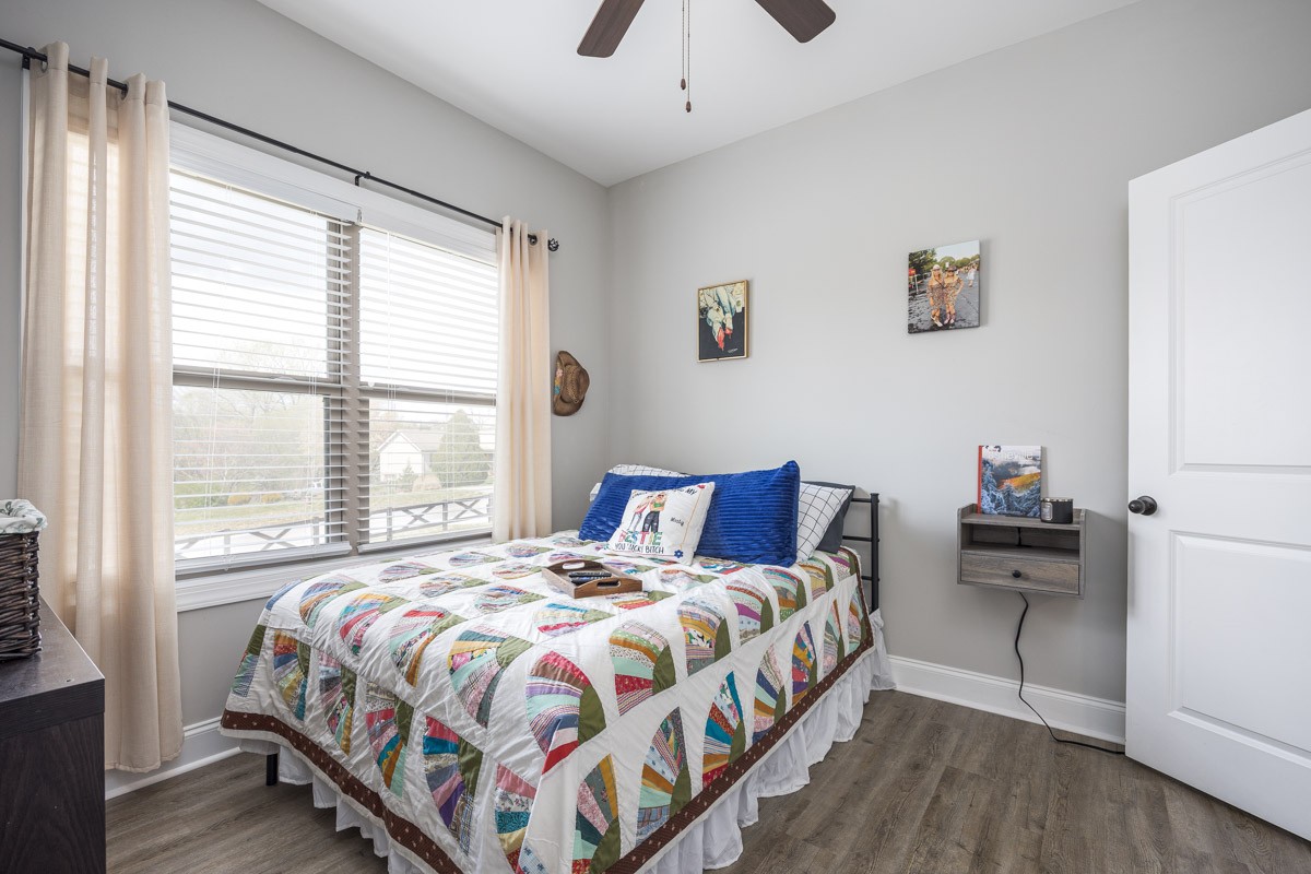 2743 West County Farm Road Springfield, TN 37172 - Photo 30 of 53 a bedroom with a bed and a chandelier