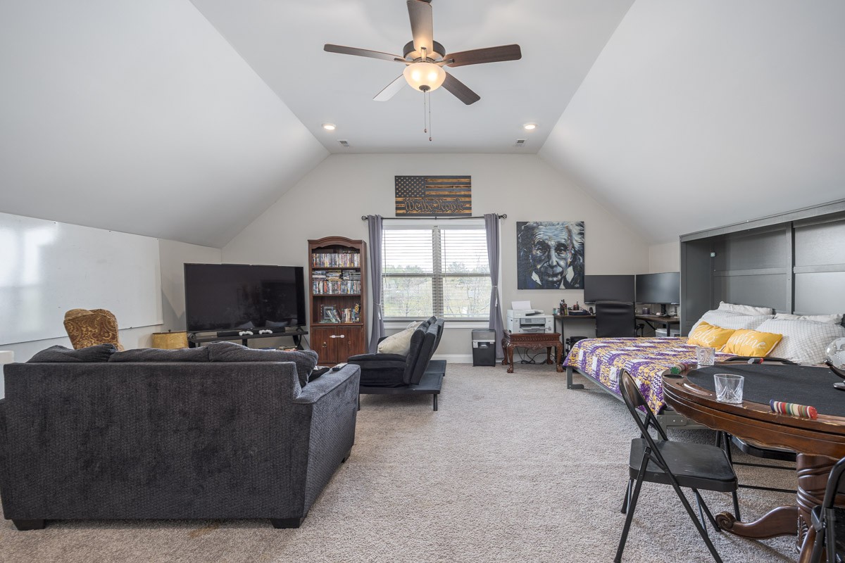 2743 West County Farm Road Springfield, TN 37172 - Photo 36 of 53 a living room with furniture a chandelier and a flat screen tv