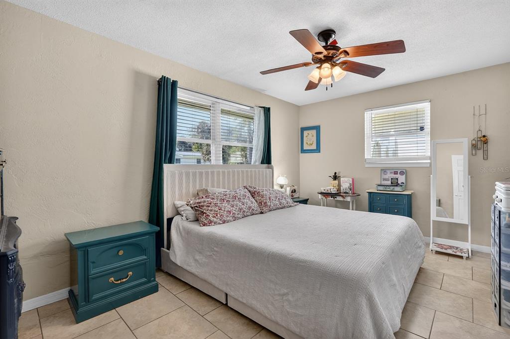 327 London Road Daytona Beach, FL 32117 - Photo 15 of 42 a bedroom with a bed and a chandelier