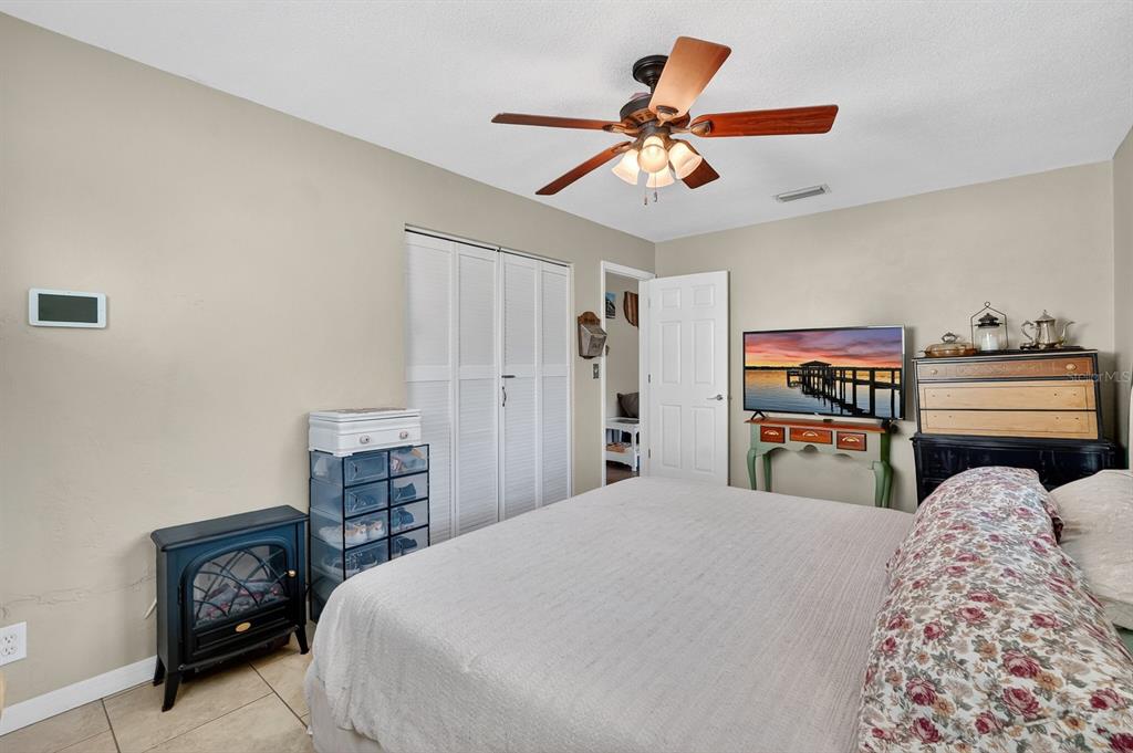 327 London Road Daytona Beach, FL 32117 - Photo 16 of 42 a bedroom with a bed and a chandelier