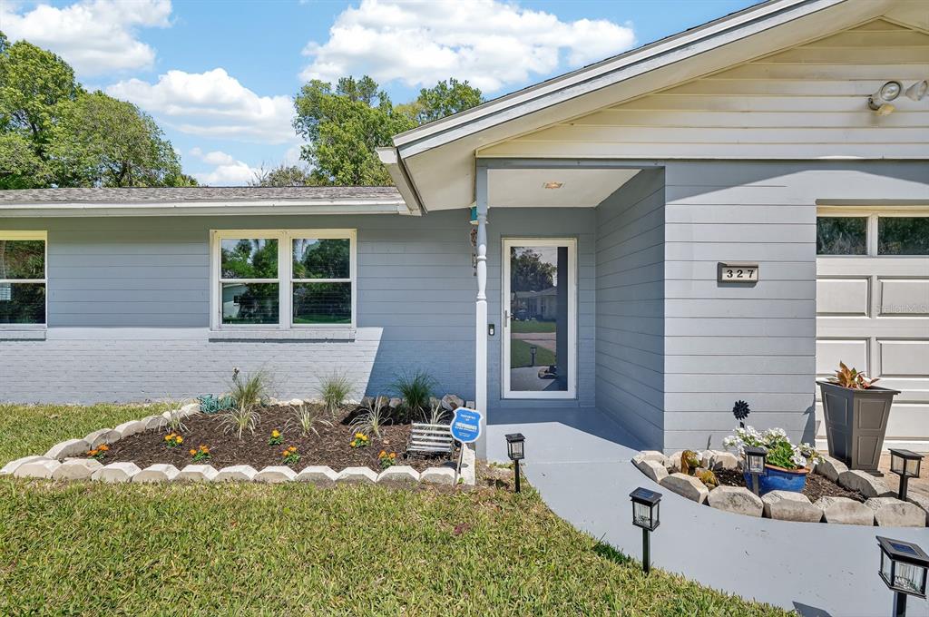 327 London Road Daytona Beach, FL 32117 - Photo 2 of 42 a front view of a house with yard