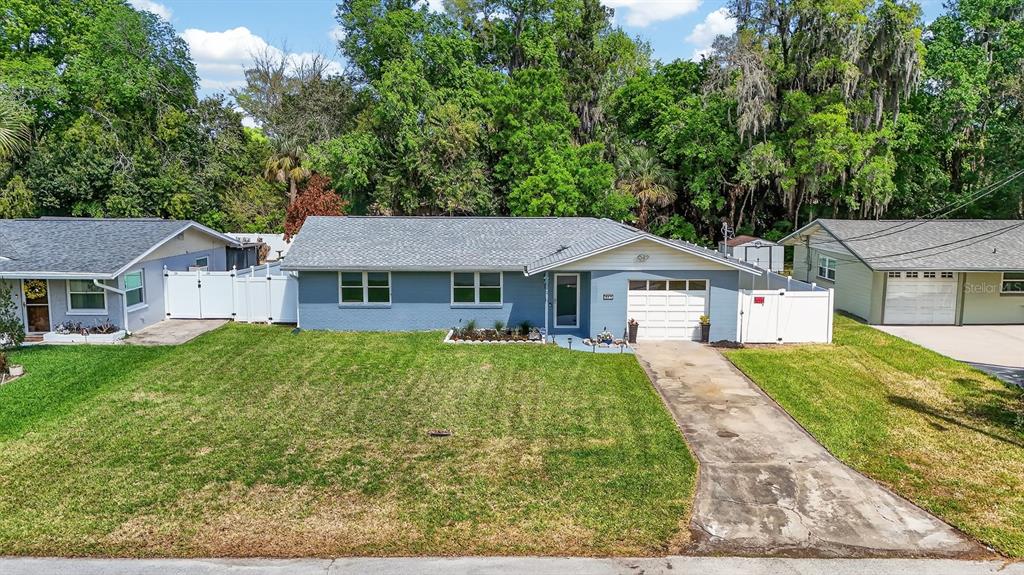 327 London Road Daytona Beach, FL 32117 - Photo 26 of 42 a front view of a house with garden