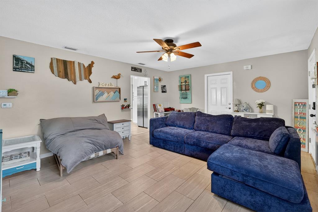 327 London Road Daytona Beach, FL 32117 - Photo 4 of 42 a living room with furniture and a chandelier
