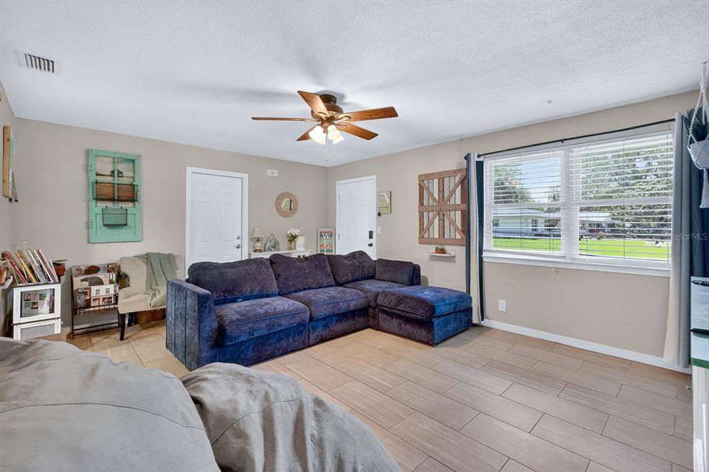 327 London Road Daytona Beach, FL 32117 - Photo 5 of 42 a living room with furniture and a large window