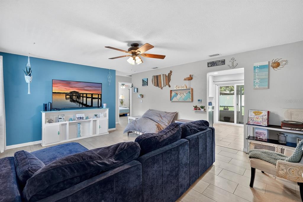 327 London Road Daytona Beach, FL 32117 - Photo 6 of 42 a living room with furniture and a flat screen tv