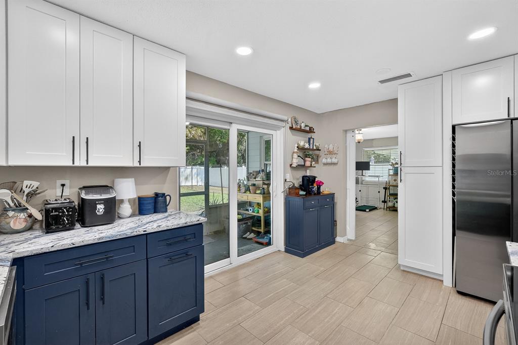 327 London Road Daytona Beach, FL 32117 - Photo 10 of 42 a kitchen with refrigerator and cabinets