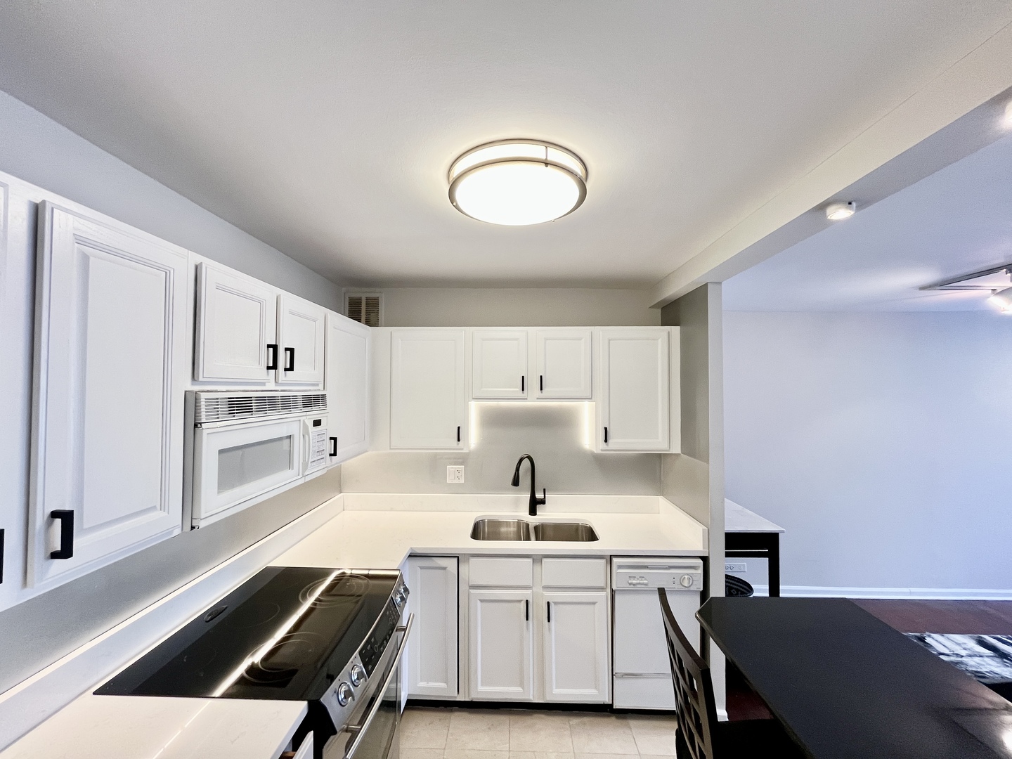 100 East Walton Place, Unit 14A Chicago, IL 60611 - Photo 2 of 19 a kitchen that has a sink a stove and white cabinets