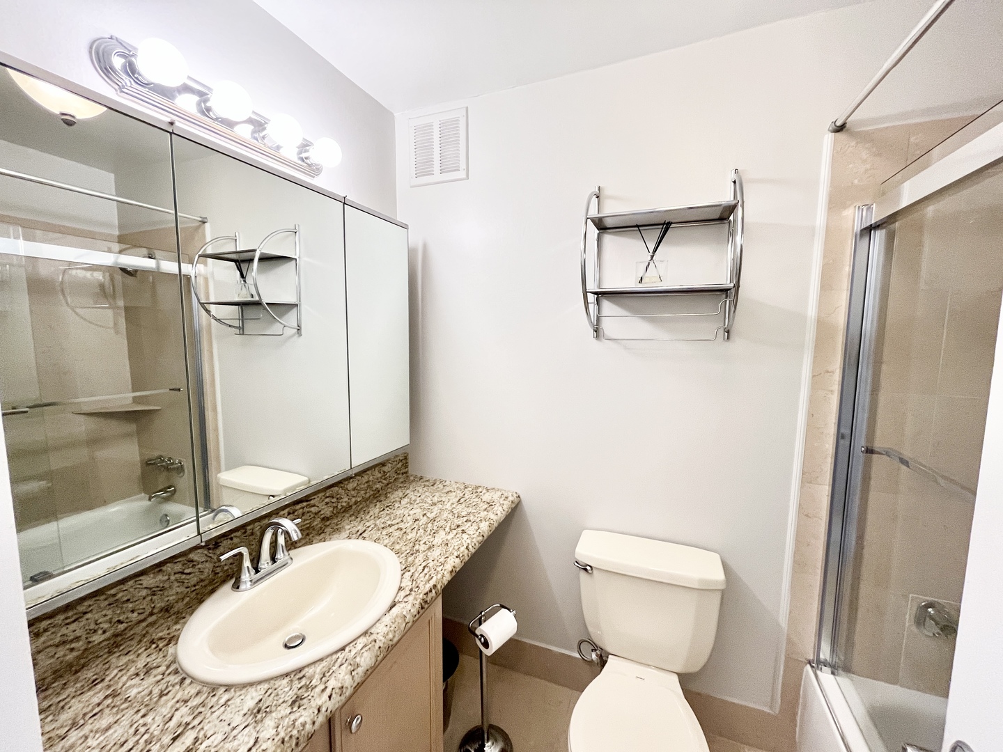 100 East Walton Place, Unit 14A Chicago, IL 60611 - Photo 10 of 19 a bathroom with a sink toilet a mirror and shower