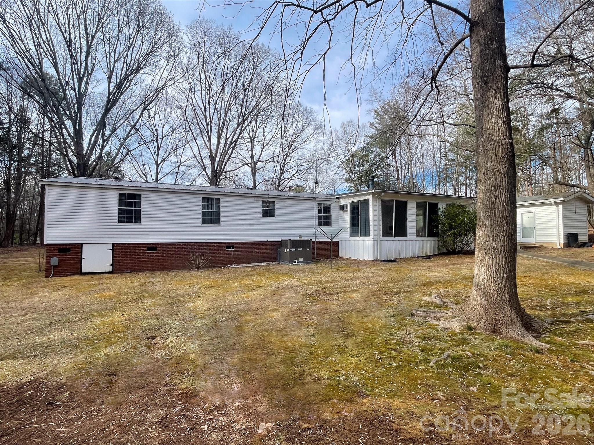 205 Star Road York, SC 29745 - Photo 15 of 15 a backyard of a house with large trees and table and chairs