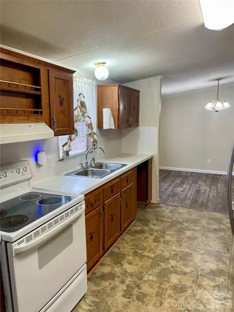 a kitchen with stainless steel appliances granite countertop a sink and cabinets