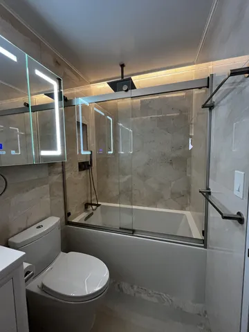 a bathroom with a toilet sink and shower