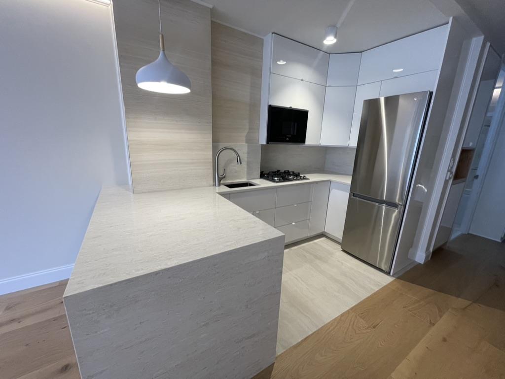 Undisclosed Address Manhattan, NY 10019 - Photo 4 of 13 a kitchen with stainless steel appliances a refrigerator and a television