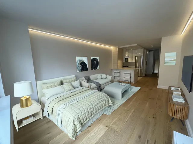 a kitchen with stainless steel appliances a refrigerator and a television