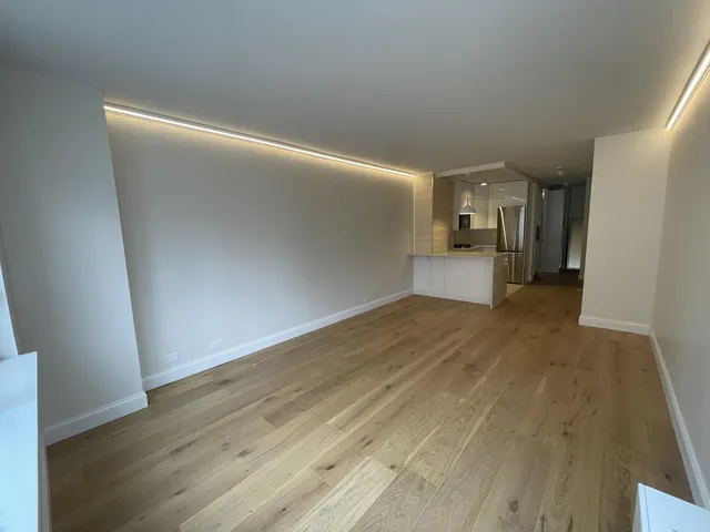 a bed room with two bed and a lamp