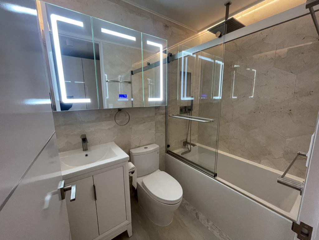 Undisclosed Address Manhattan, NY 10019 - Photo 9 of 13 a bathroom with a toilet sink and shower