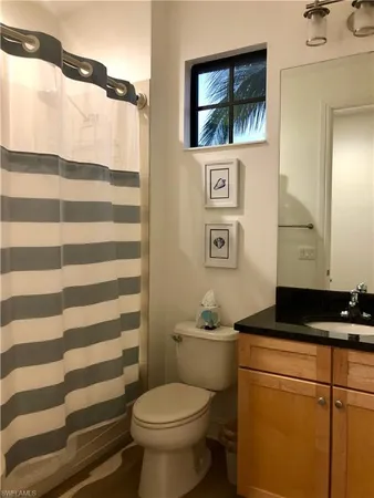 a bathroom with a toilet a sink and a mirror