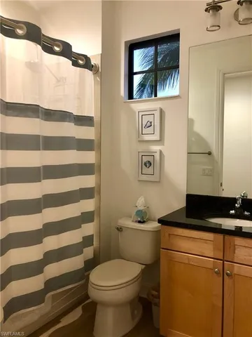 a bathroom with a toilet a sink and a mirror