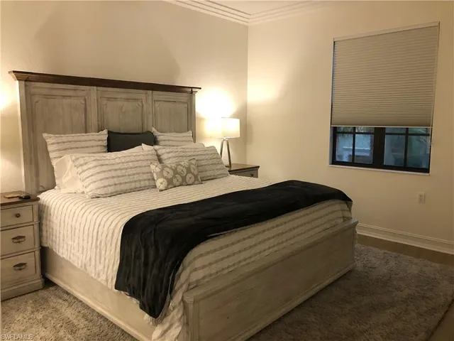 a bedroom with a bed and a night stand