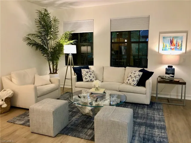 a living room with furniture and a potted plant