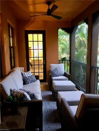 a living room with furniture and a floor to ceiling window