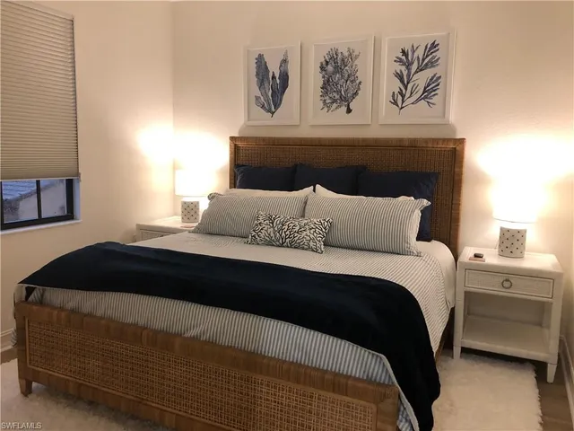 a bedroom with a bed and a night stand